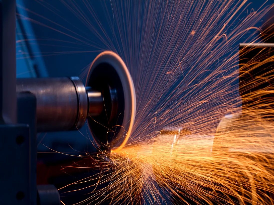 Cutting tool being reground, sparks leaving the wheel