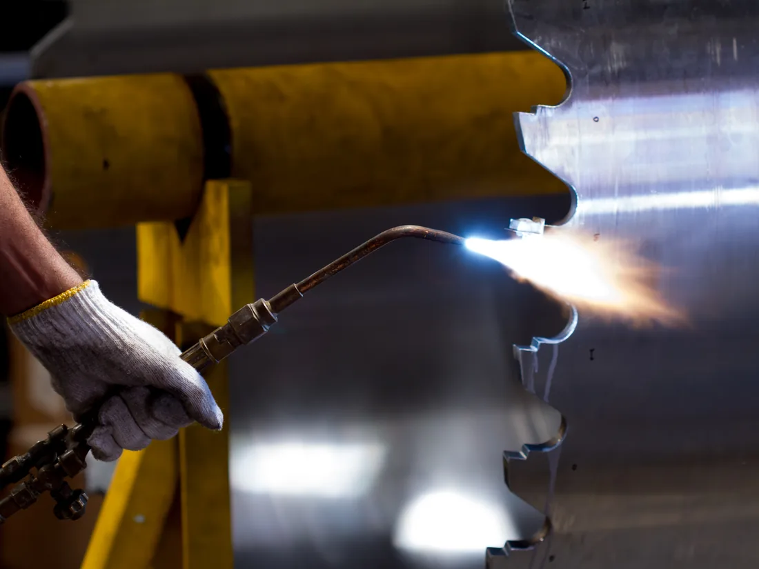 Carbide tip being brazed onto a tool body with a gas torch