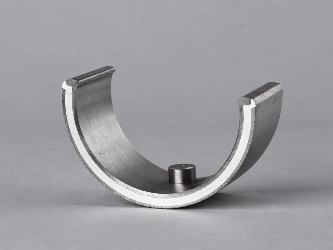White metal lined journal bearing pad, an arc segment with a pivot boss